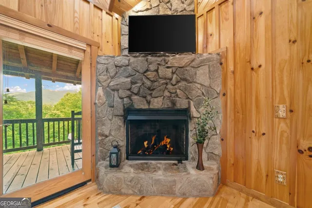 a living room with a fireplace and a flat screen tv