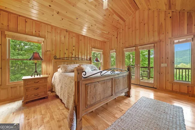 a bed room with a bed and a large window