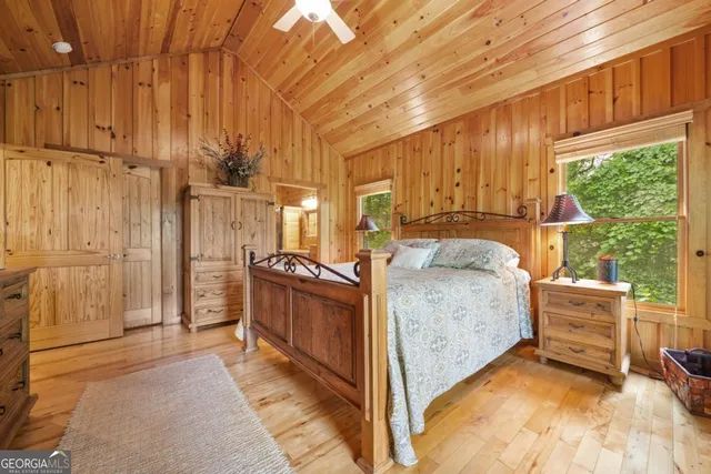 a bed room with a bed and next to a window