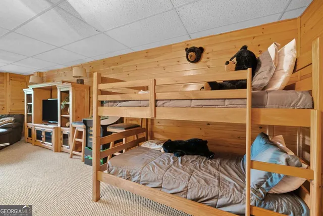 a bedroom with a bed window and a chandelier
