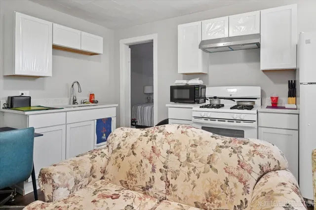 a kitchen with a sink a stove and cabinets