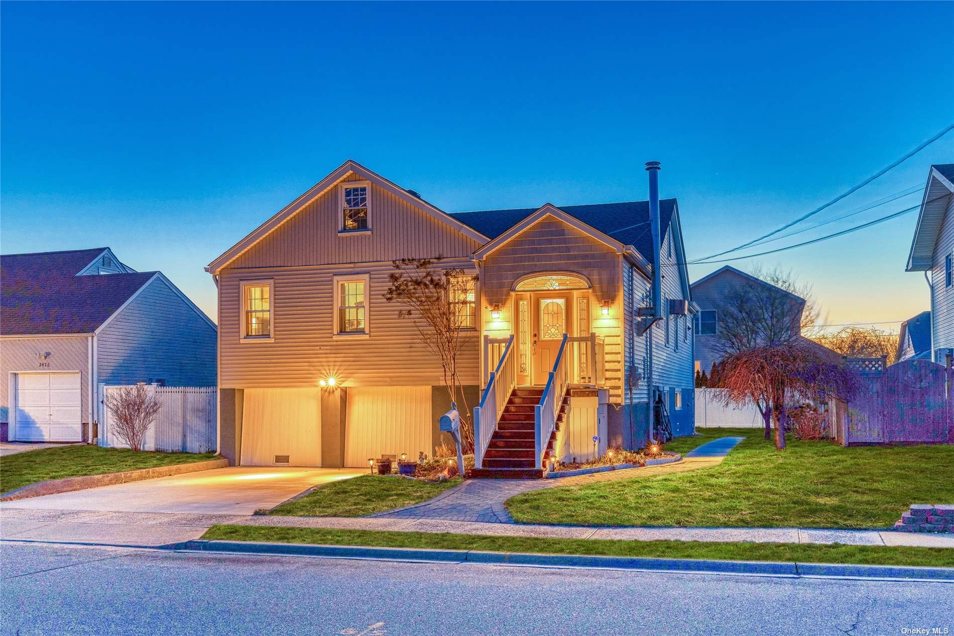 2470 Riverside Drive Wantagh, NY 11793 - Photo 1 of 1 a front view of a house with a yard and potted plants