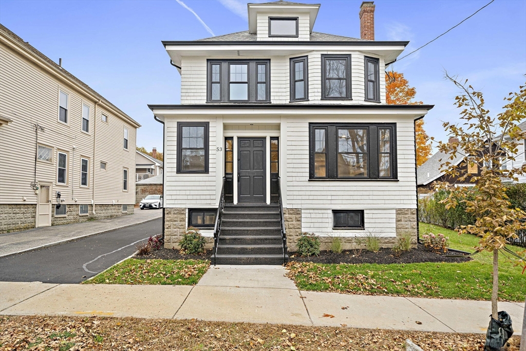 a front view of a house with a garden