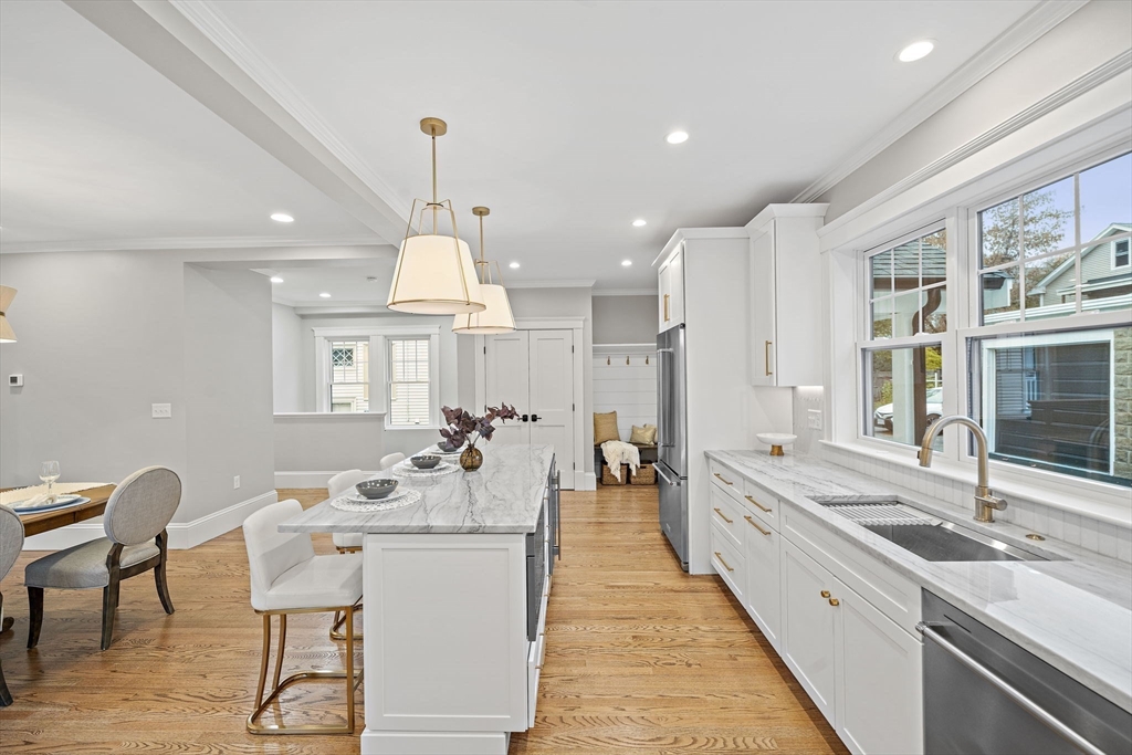 53 Highland Avenue Arlington, MA 02476 - Photo 11 of 34 a large dining hall with stainless steel appliances kitchen island granite countertop a sink and cabinets