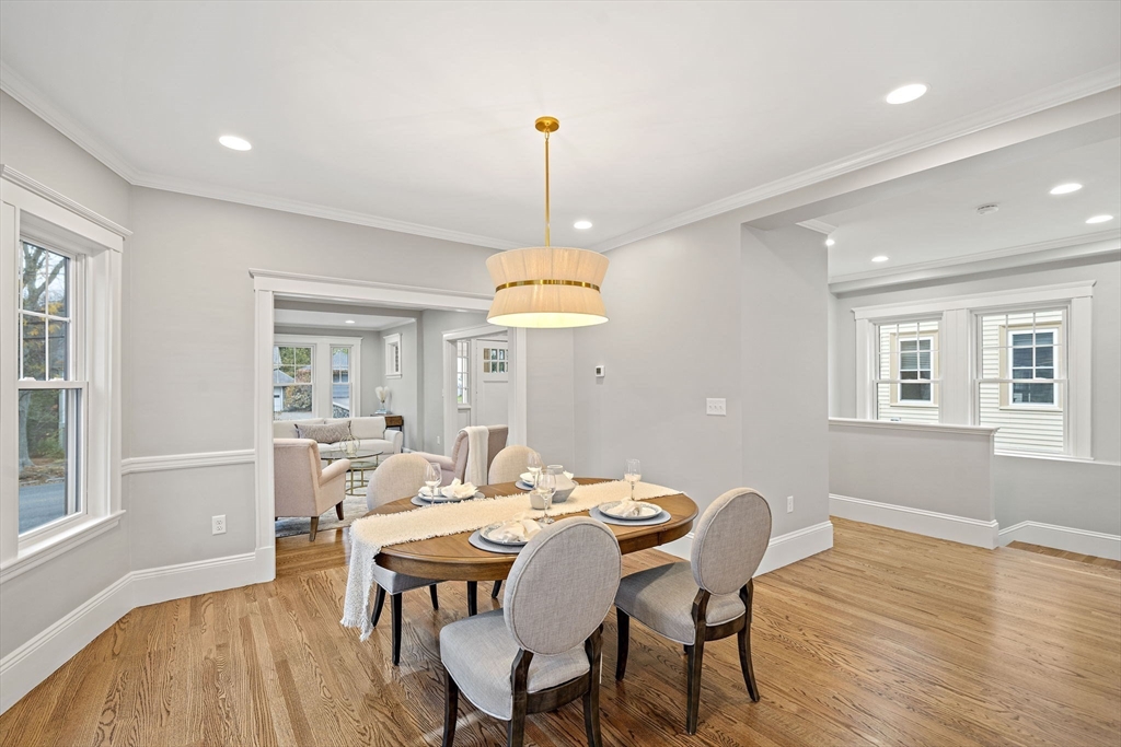 53 Highland Avenue Arlington, MA 02476 - Photo 13 of 34 a dining room with furniture a chandelier and wooden floor