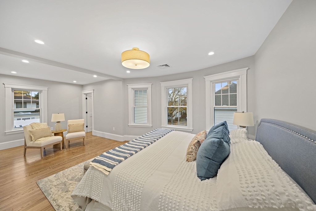 53 Highland Avenue Arlington, MA 02476 - Photo 16 of 34 a bedroom with a bed and wooden floor