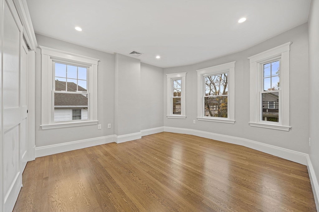53 Highland Avenue Arlington, MA 02476 - Photo 22 of 34 a view of an empty room with a window and wooden floor