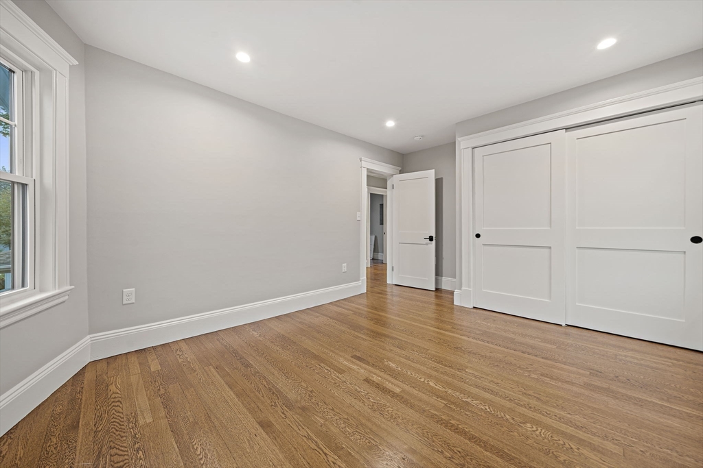 53 Highland Avenue Arlington, MA 02476 - Photo 23 of 34 a view of an empty room with wooden floor and a window