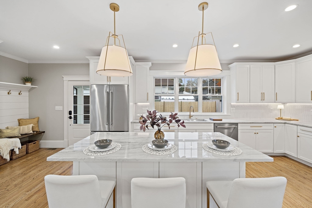 53 Highland Avenue Arlington, MA 02476 - Photo 10 of 34 a kitchen with a dining table and chairs