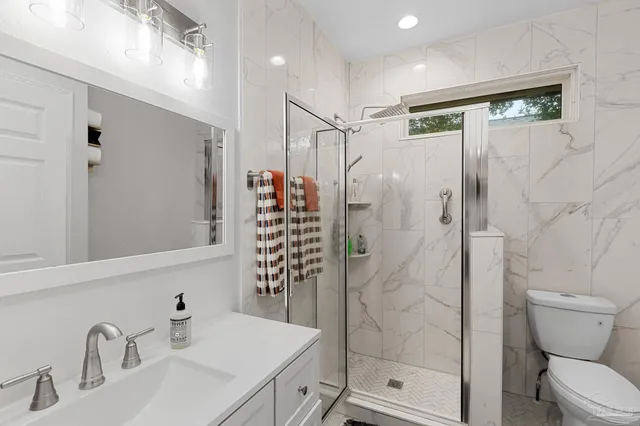 a bathroom with a shower toilet and sink