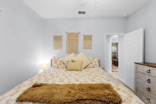 a bedroom with a bed and a tv