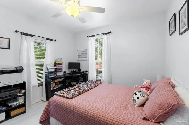 a bedroom with a bed and a flat tv screen