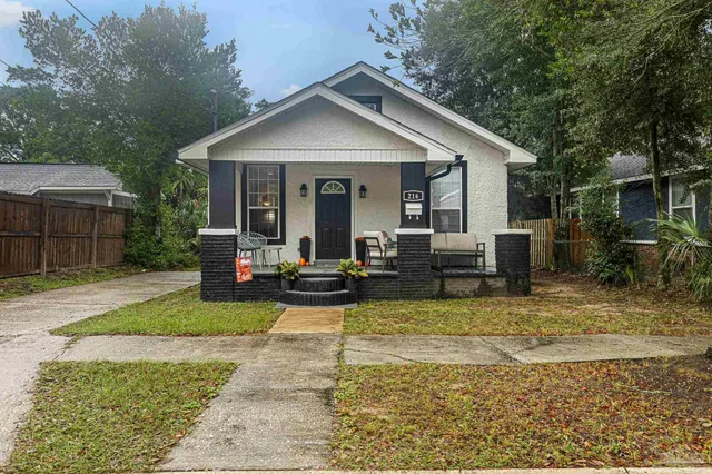 a view of a house with backyard and sitting area