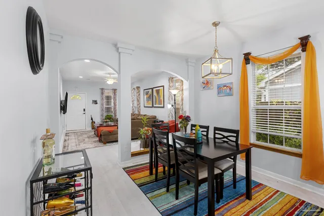 a view of a dining room with furniture and a window
