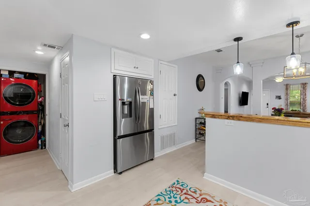 a view of a kitchen with a refrigerator washer and dryer