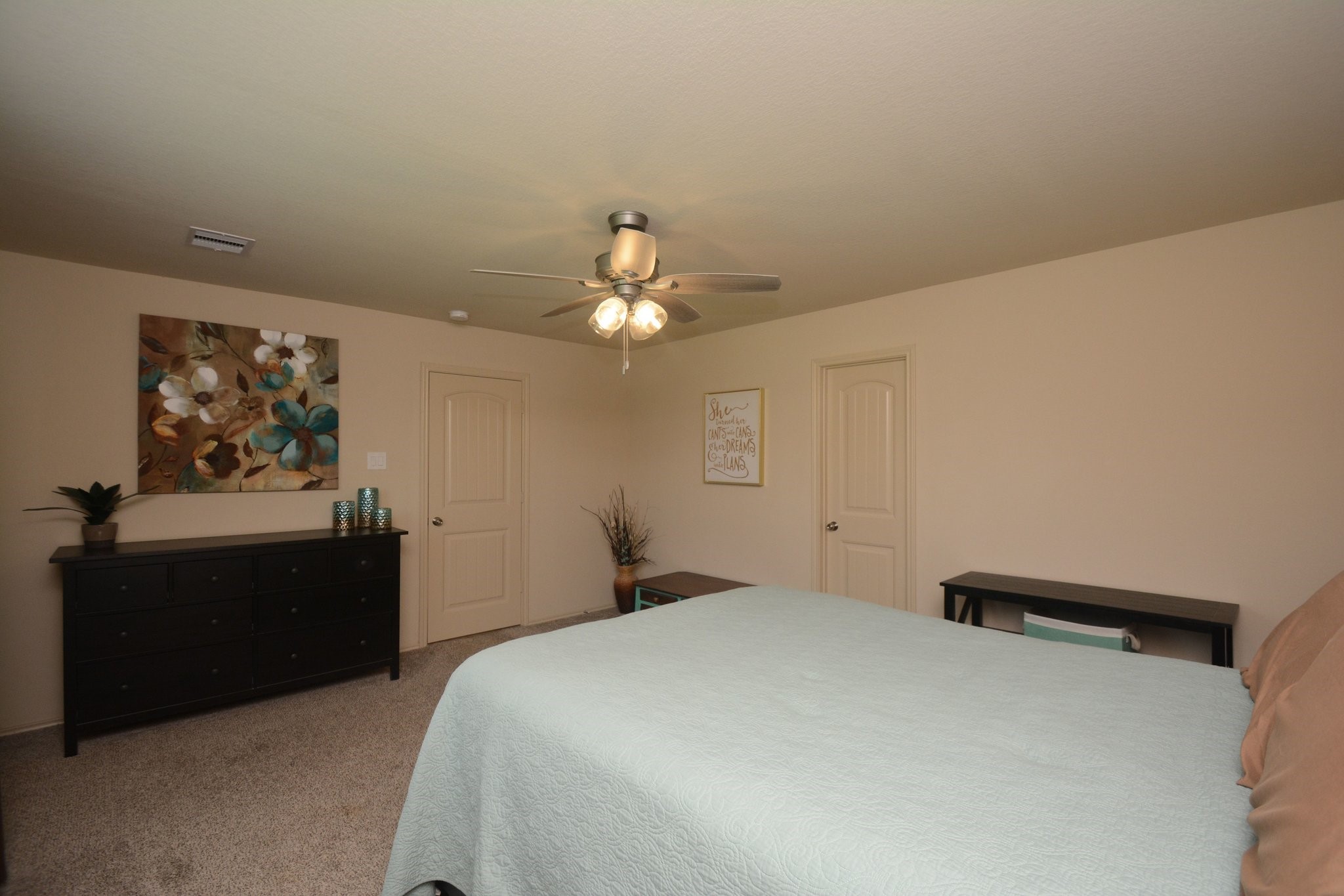 23318 Dukes Run Drive Spring, TX 77373 - Photo 27 of 41 This spacious bedroom features neutral walls, carpeted flooring, and a ceiling fan. It has a cozy and inviting atmosphere.