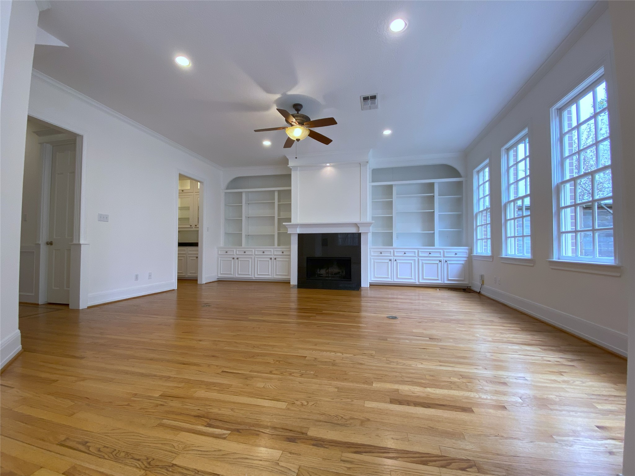 3024 Rice Boulevard Houston, TX 77005 - Photo 10 of 38 The family room is so spacious! Enjoy a wood burning fireplace, built-in cabinets/shelving, recessed lighting & ceiling fan.