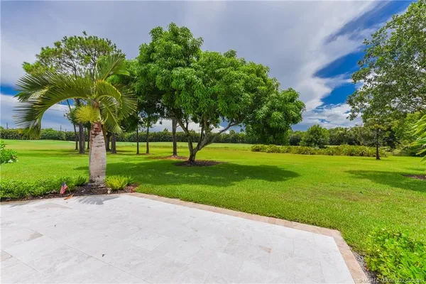 a spacious bathroom with a double vanity sink a large mirror and a bathtub