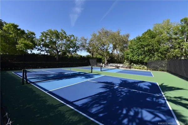 a view of a park with lawn chairs and a yard