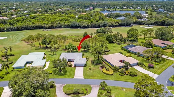 a front view of a house with a garden and trees
