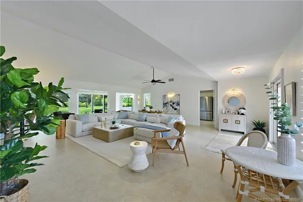 a living room with furniture and a floor to ceiling window