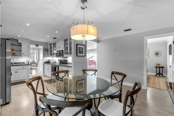 a dining room with furniture and window
