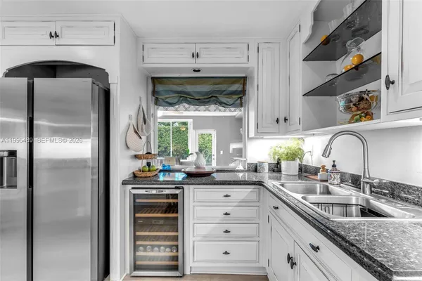 a kitchen with stainless steel appliances a sink stove and refrigerator