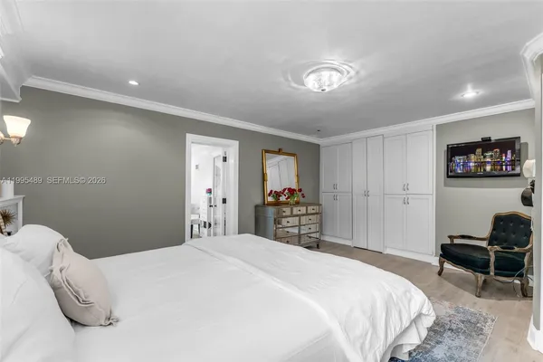 a bedroom with a bed and a chair