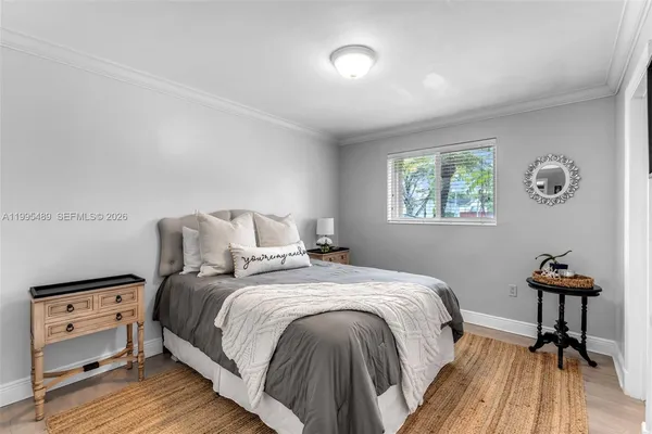 a bedroom with a bed and a table