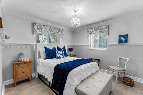 a bed room with a bed and a chair