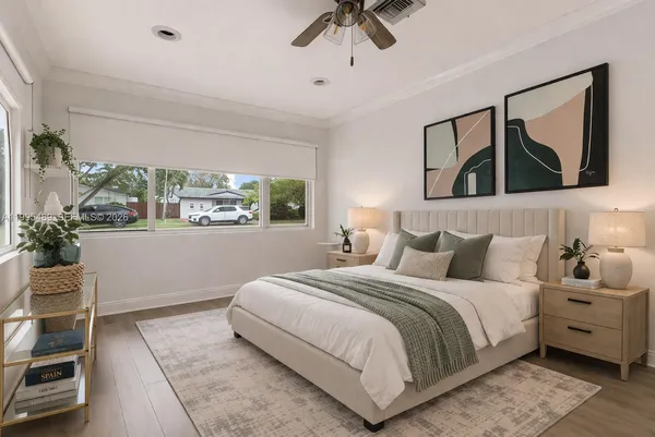 a bedroom with a large bed and a painting on the wall