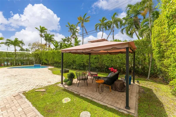 swimming pool view with a seating space
