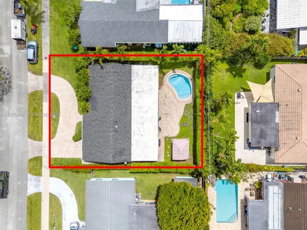 an aerial view of residential houses with outdoor space