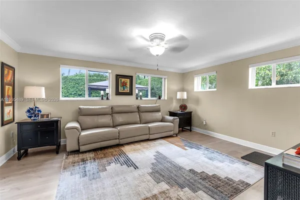 a living room with furniture and a large window