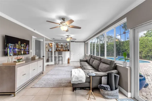 a living room with furniture a dining table and a large window