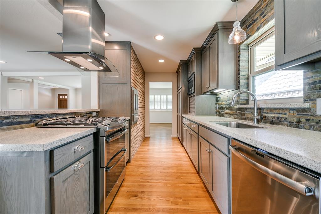 6815 Santa Maria Lane Dallas, TX 75214 - Photo 12 of 24 a kitchen with stainless steel appliances granite countertop a stove and a sink