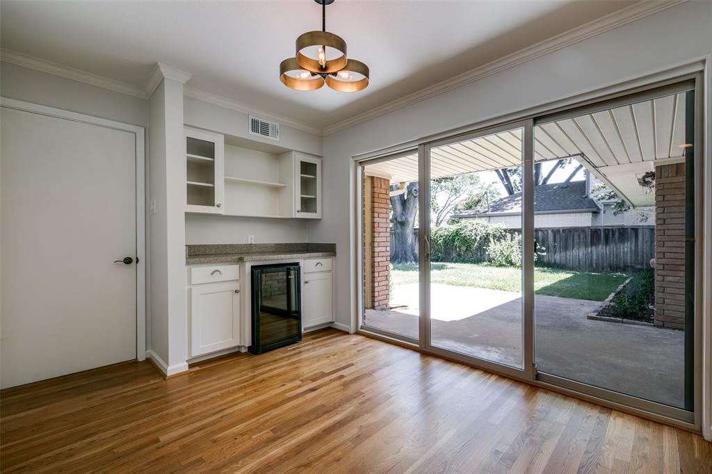 6815 Santa Maria Lane Dallas, TX 75214 - Photo 14 of 24 a view of an empty room with a window and wooden floor