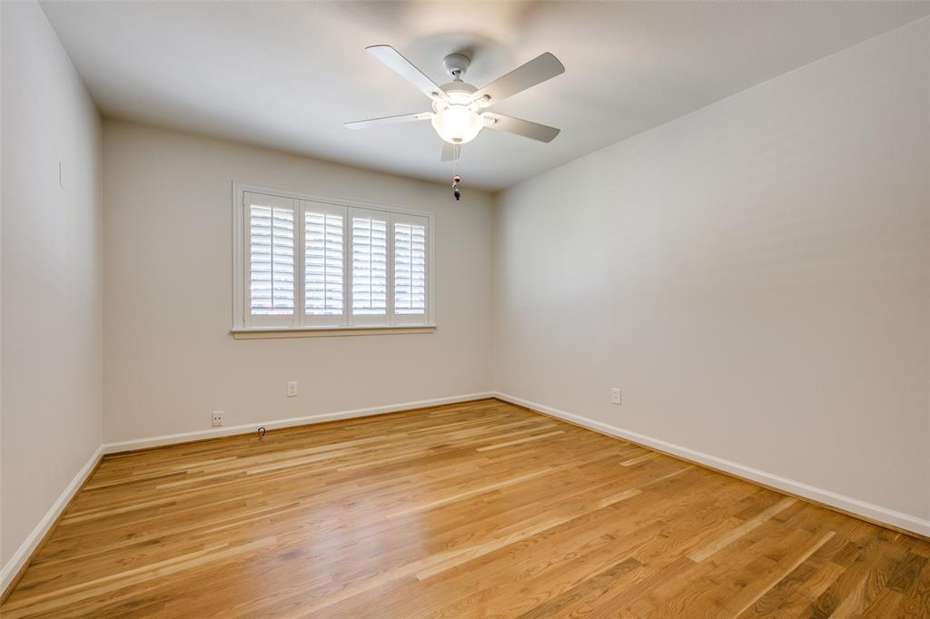 6815 Santa Maria Lane Dallas, TX 75214 - Photo 17 of 24 an empty room with windows and ceiling fan