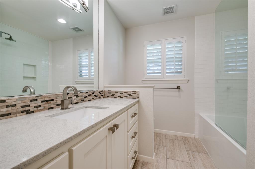 6815 Santa Maria Lane Dallas, TX 75214 - Photo 19 of 24 a bathroom with a sink vanity and tub