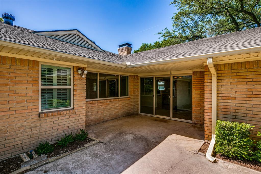 6815 Santa Maria Lane Dallas, TX 75214 - Photo 20 of 24 a view of a house with a large window and flower plants