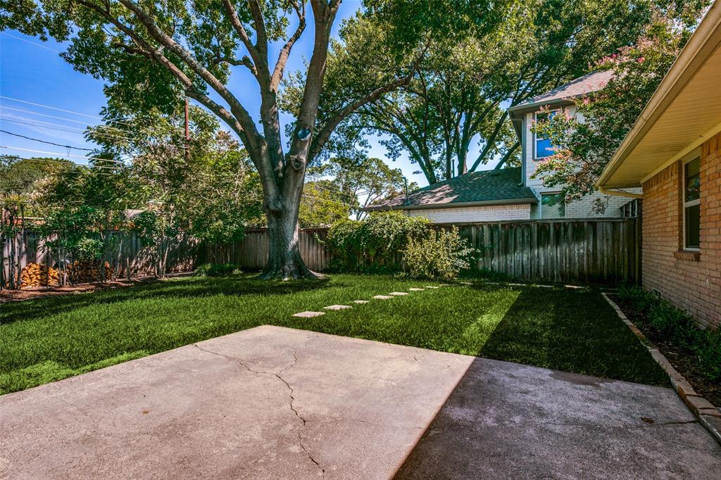 6815 Santa Maria Lane Dallas, TX 75214 - Photo 21 of 24 a view of a yard with plants and large trees