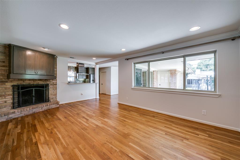6815 Santa Maria Lane Dallas, TX 75214 - Photo 6 of 24 a view of an empty room with a window and fireplace