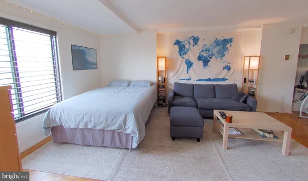 a bedroom with a bed and a couch