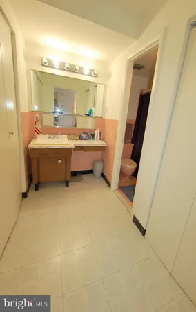 a large bathroom with a tub sink and mirror