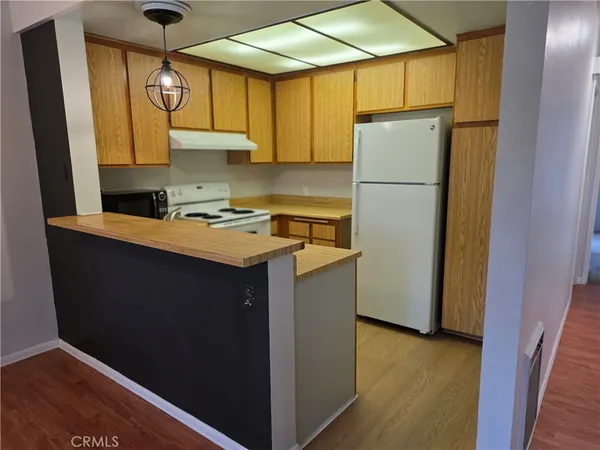 a kitchen with a refrigerator a stove a sink and a window