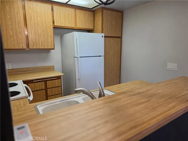 a kitchen with a refrigerator and a stove