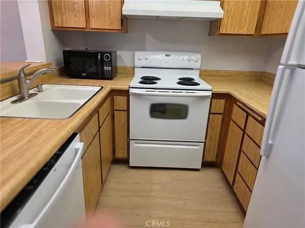 a kitchen with a stove top oven and sink