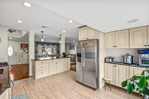 a kitchen with stainless steel appliances granite countertop a refrigerator sink and cabinets