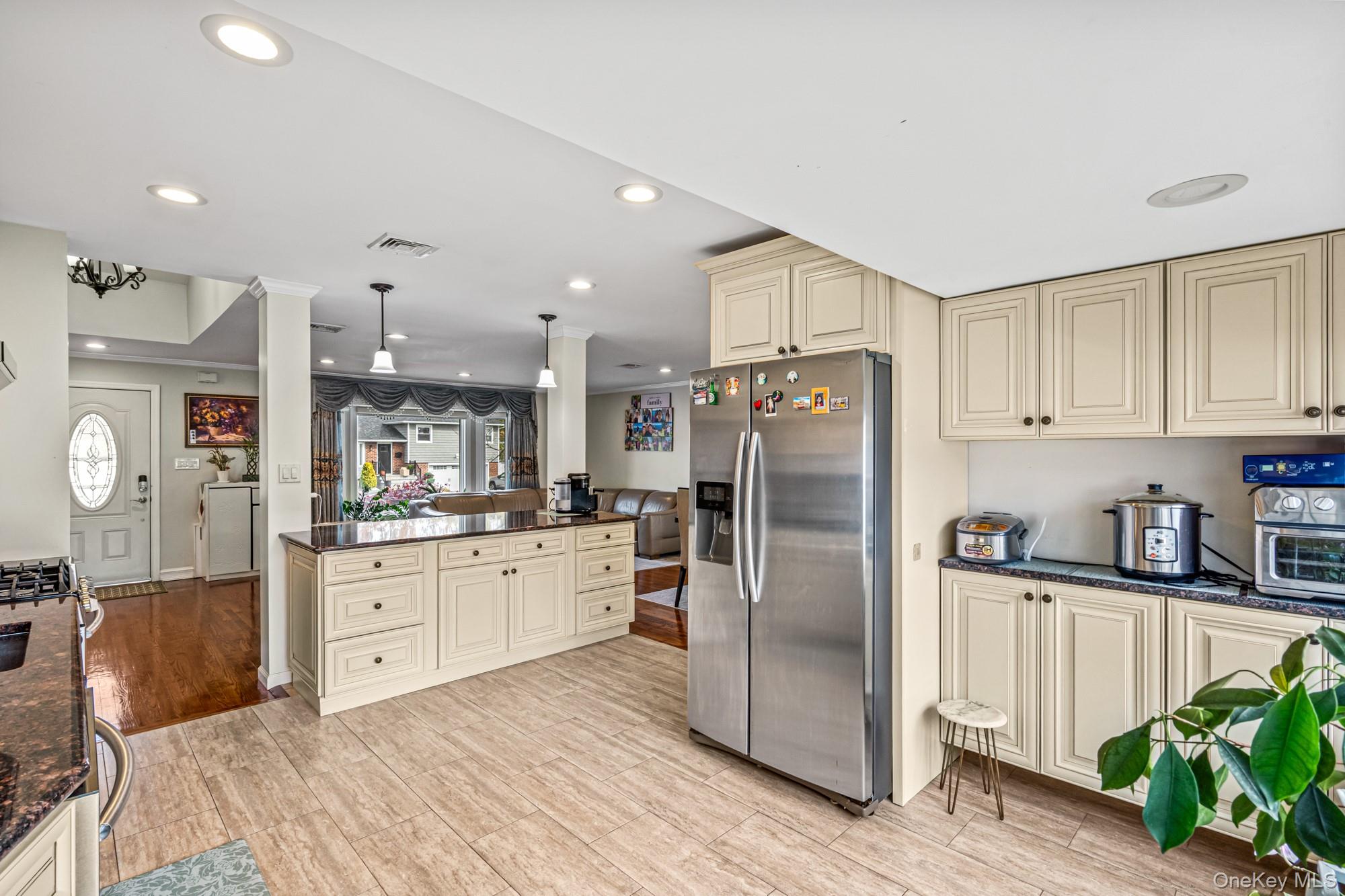 15 Vista Road Plainview, NY 11803 - Photo 11 of 26 a kitchen with stainless steel appliances granite countertop a refrigerator sink and cabinets