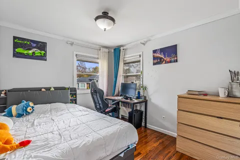 a bed room with a bed window and a chair